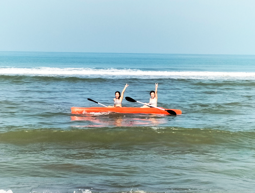 Kayaking Adventure at Beach Camp: A vibrant image of a guest paddling a kayak in the crystal-clear waters near Beach Camp, La Union, showcasing the exhilarating water sports experience.