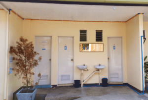 A spotless, well-maintained restroom at Beach Camp, reflecting the high standards of cleanliness and hygiene. The interior features modern fixtures and bright lighting, emphasizing comfort and convenience for guests. Tiled floors and walls gleam under the light, showcasing the resort's commitment to providing a clean and inviting environment for all visitors.